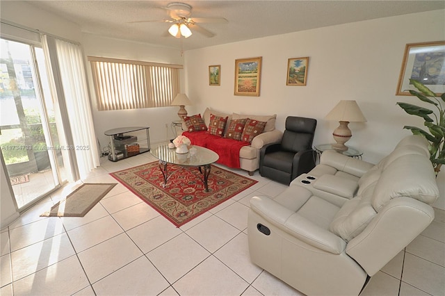 living room featuring ceiling fan, a textured ceiling, and light tile patterned floors