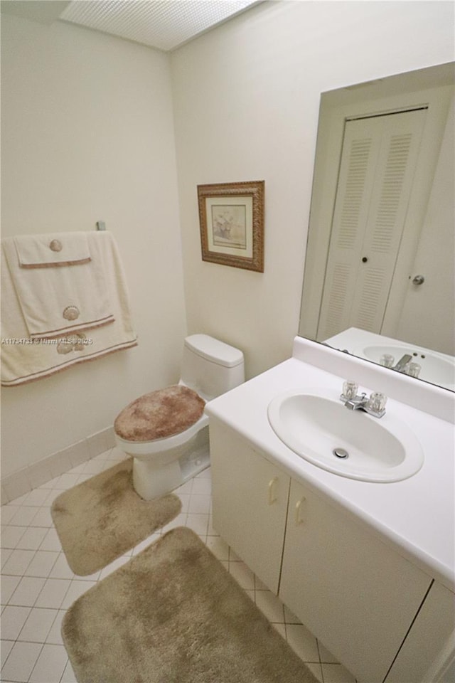 bathroom featuring vanity, toilet, and tile patterned flooring