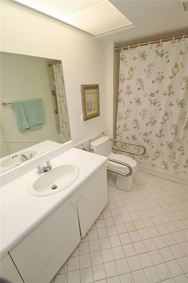 full bathroom with vanity, toilet, tile patterned flooring, and shower / bath combo with shower curtain