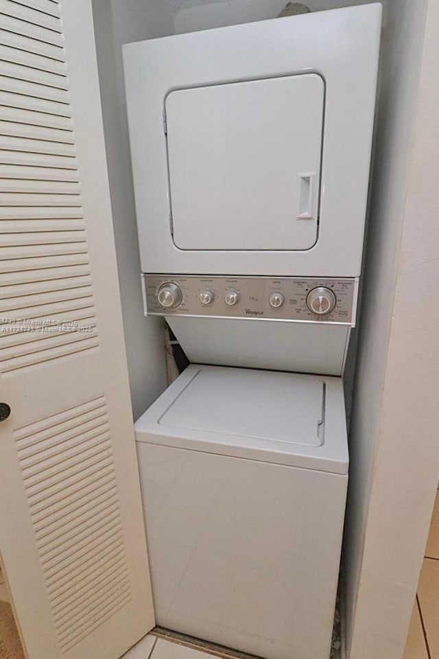 laundry area with stacked washer and dryer