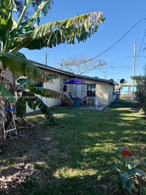 back of house with a lawn