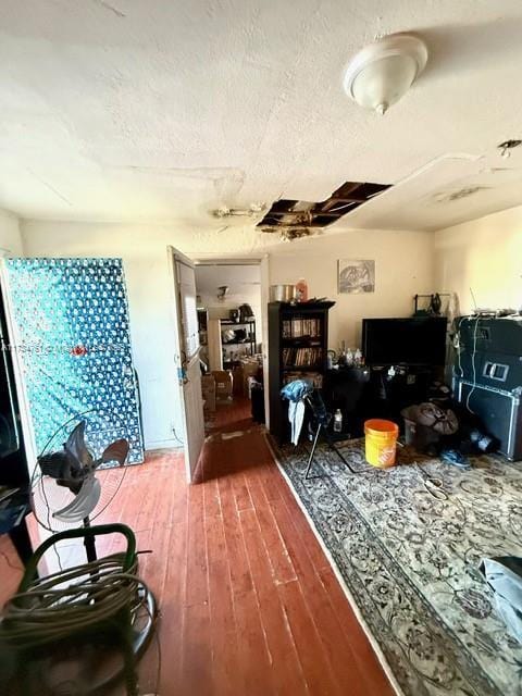 misc room featuring wood-type flooring and a textured ceiling