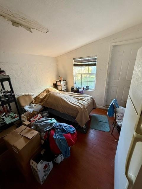 bedroom featuring vaulted ceiling and dark hardwood / wood-style floors