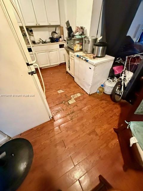 kitchen with white cabinetry and wood-type flooring