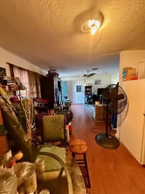 living room with hardwood / wood-style flooring and a textured ceiling