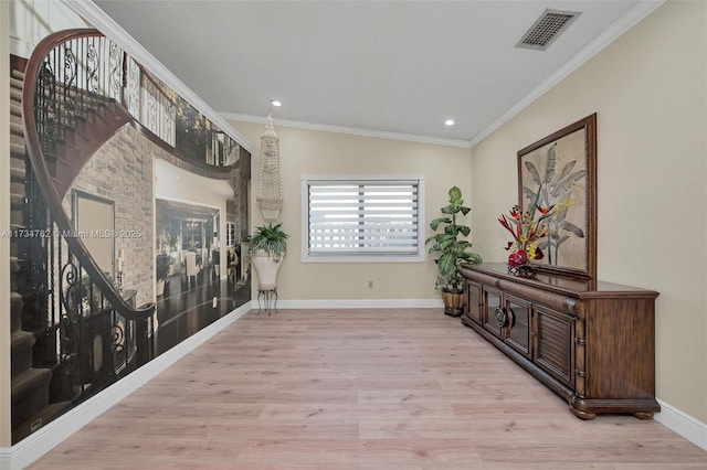 hallway featuring ornamental molding and light wood-type flooring