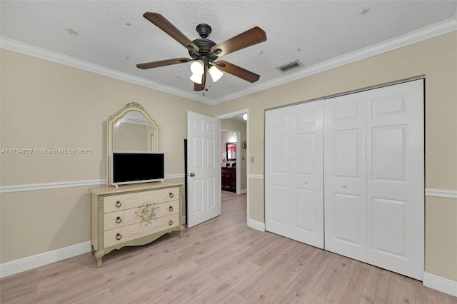 unfurnished bedroom featuring a closet, a textured ceiling, and light hardwood / wood-style flooring