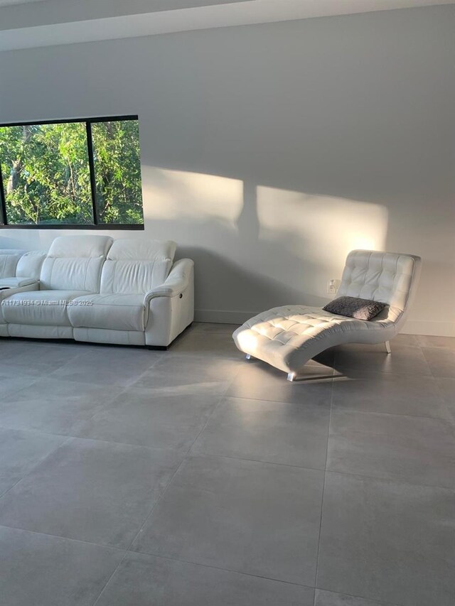 unfurnished living room featuring concrete floors