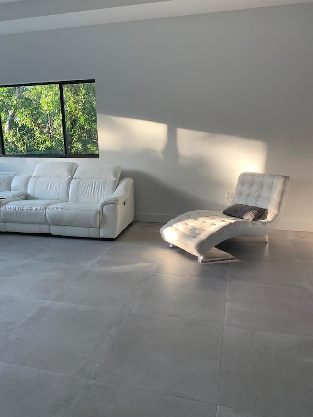 unfurnished living room with concrete flooring