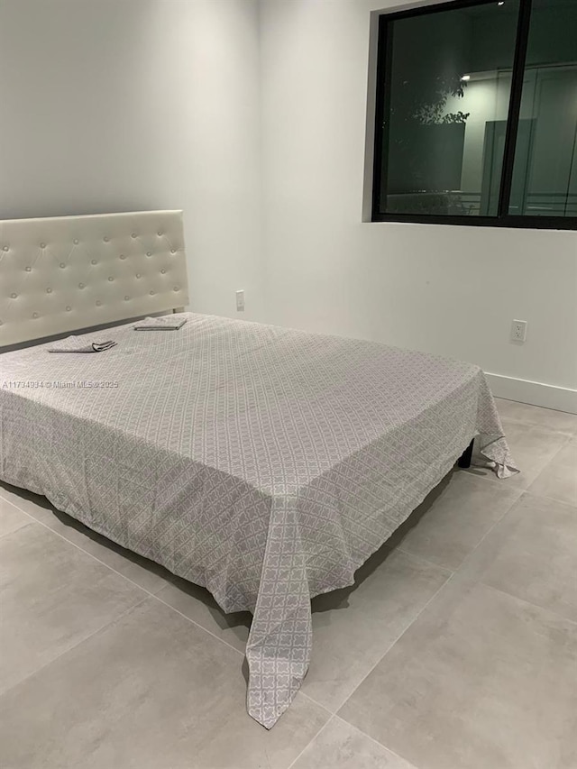 bedroom featuring concrete flooring