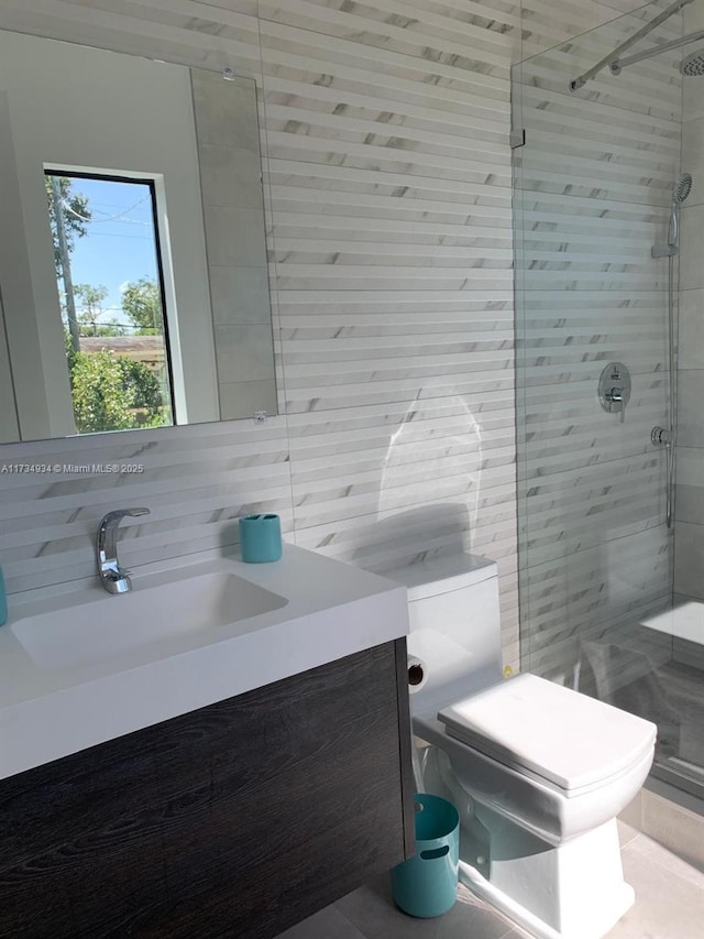 bathroom featuring tile walls, vanity, tasteful backsplash, toilet, and walk in shower