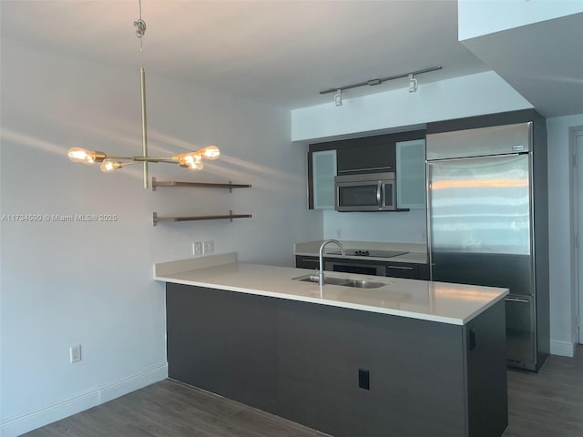 kitchen with sink, decorative light fixtures, stainless steel appliances, and kitchen peninsula