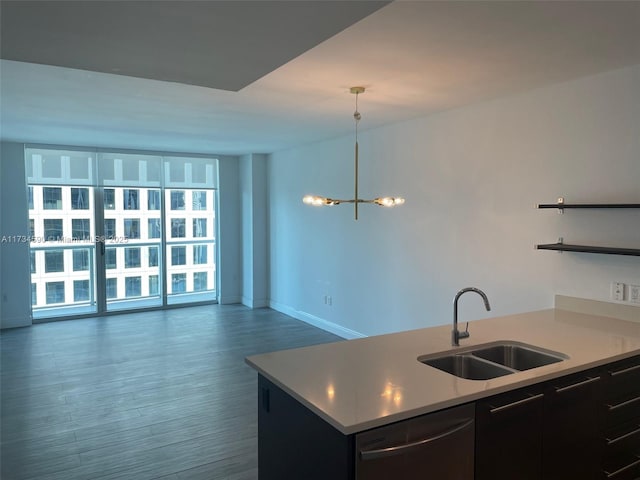 kitchen featuring sink, decorative light fixtures, dark hardwood / wood-style flooring, dishwasher, and a notable chandelier