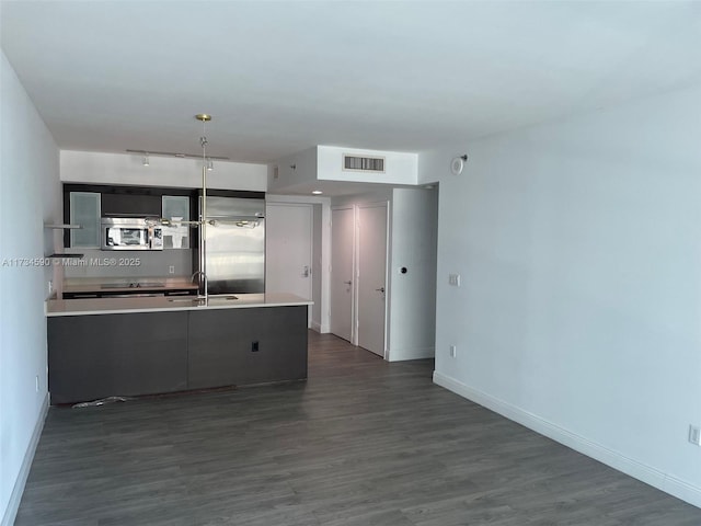 kitchen featuring stainless steel appliances, dark hardwood / wood-style flooring, and sink