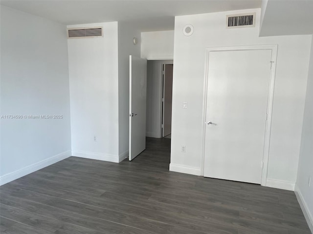 unfurnished bedroom featuring dark hardwood / wood-style flooring