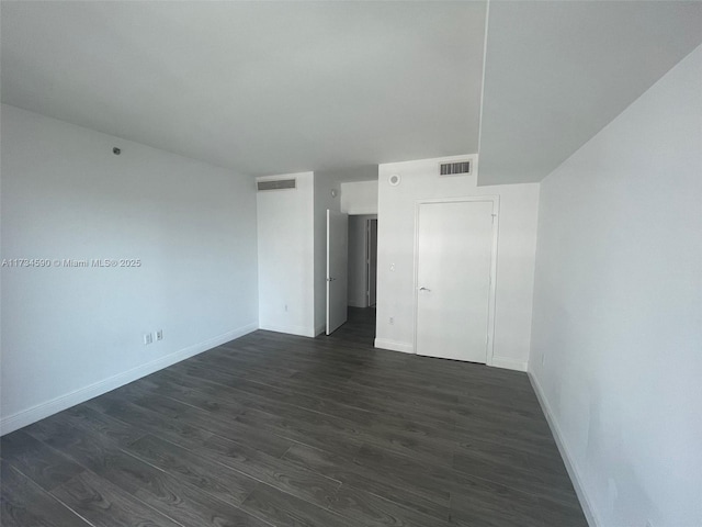 unfurnished bedroom with dark hardwood / wood-style flooring