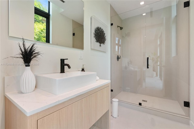 bathroom featuring vanity and an enclosed shower