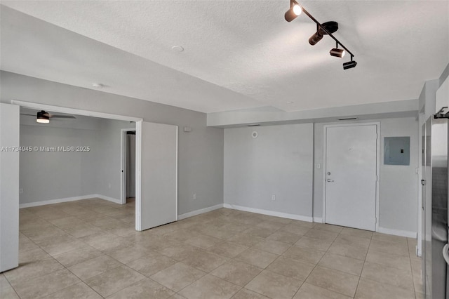 basement with electric panel and a textured ceiling