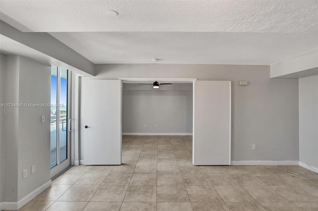 unfurnished bedroom with light tile patterned floors and a textured ceiling