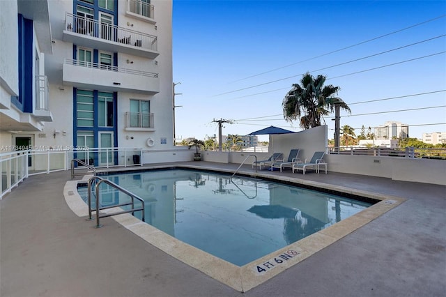 view of swimming pool featuring a patio