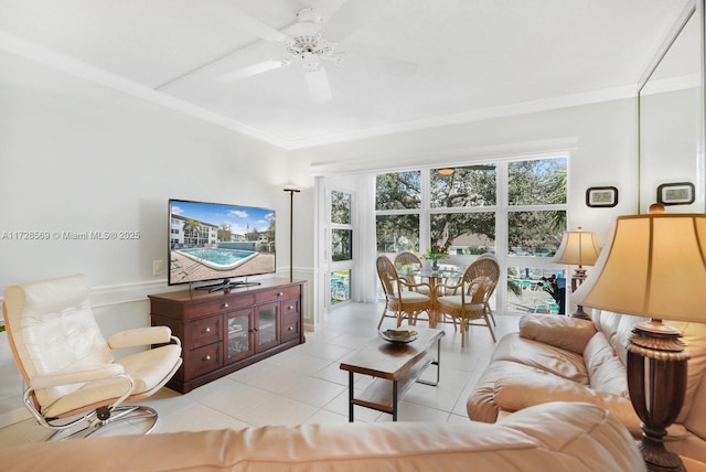 tiled living room with ceiling fan and ornamental molding