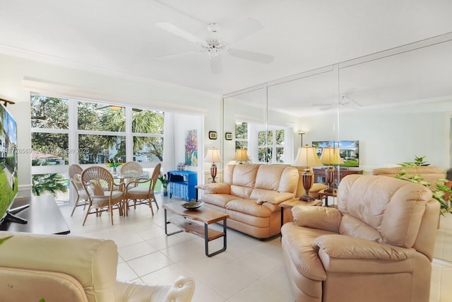 tiled living room with ornamental molding and ceiling fan