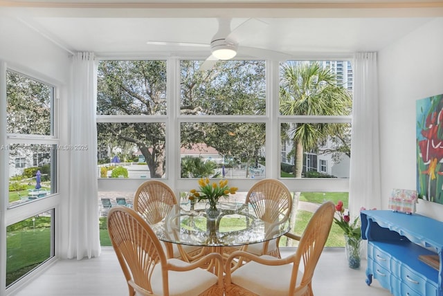 sunroom featuring ceiling fan