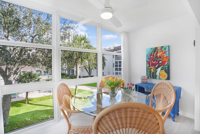 sunroom featuring ceiling fan