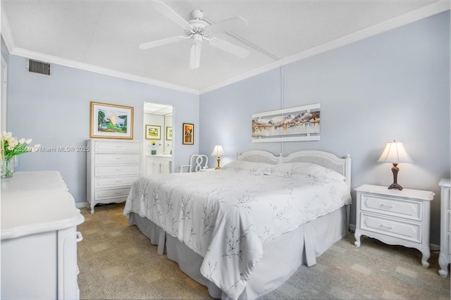 carpeted bedroom with ornamental molding, ceiling fan, and ensuite bath