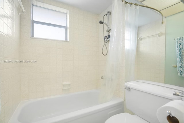 bathroom featuring shower / bath combination with curtain and toilet