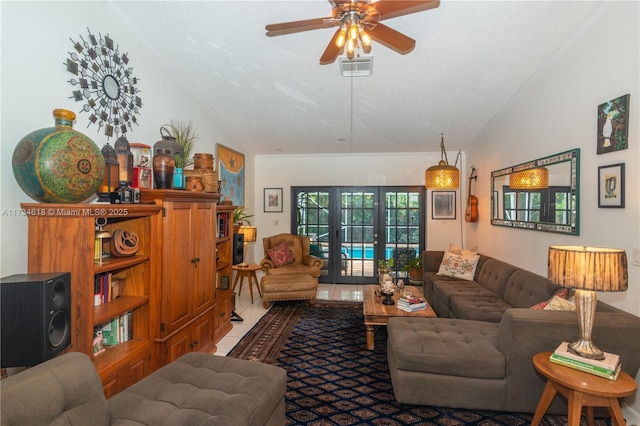 living room with french doors, tile patterned flooring, vaulted ceiling, and a textured ceiling