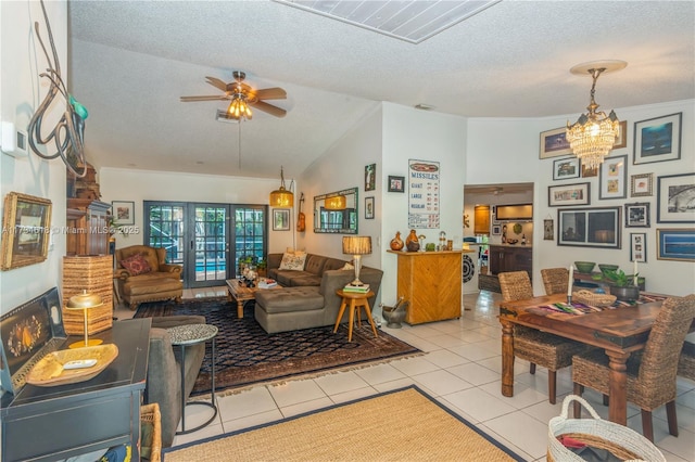 living room featuring lofted ceiling, light tile patterned floors, ceiling fan with notable chandelier, and a textured ceiling