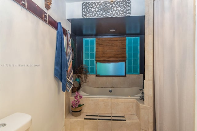 bathroom with tiled bath and toilet