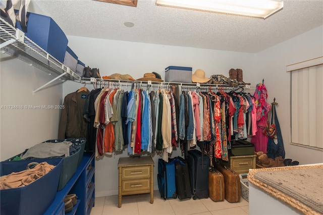 spacious closet with light tile patterned floors