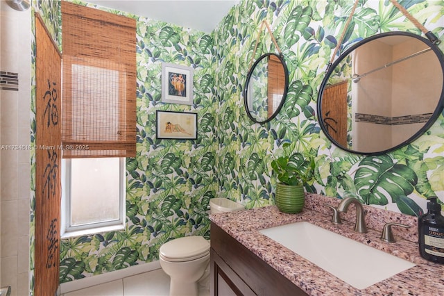 bathroom with tile patterned flooring, vanity, and toilet