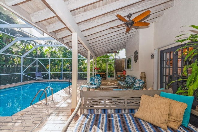 view of swimming pool featuring ceiling fan, a lanai, an outdoor hangout area, and a patio area