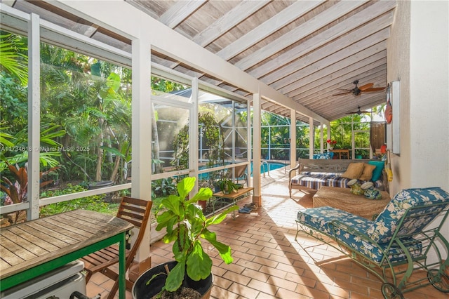 sunroom / solarium with ceiling fan and vaulted ceiling