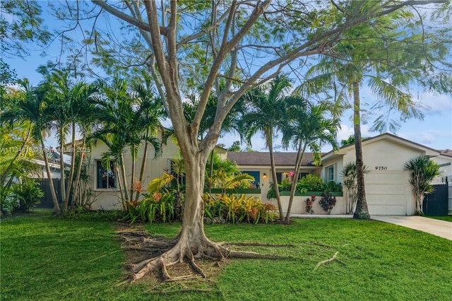 view of front of property with a garage and a front lawn