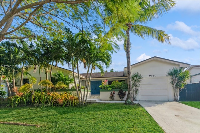 view of front of property featuring a garage and a front lawn