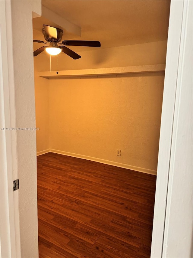 spare room with ceiling fan and dark hardwood / wood-style flooring