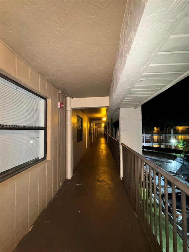 hallway with a textured ceiling