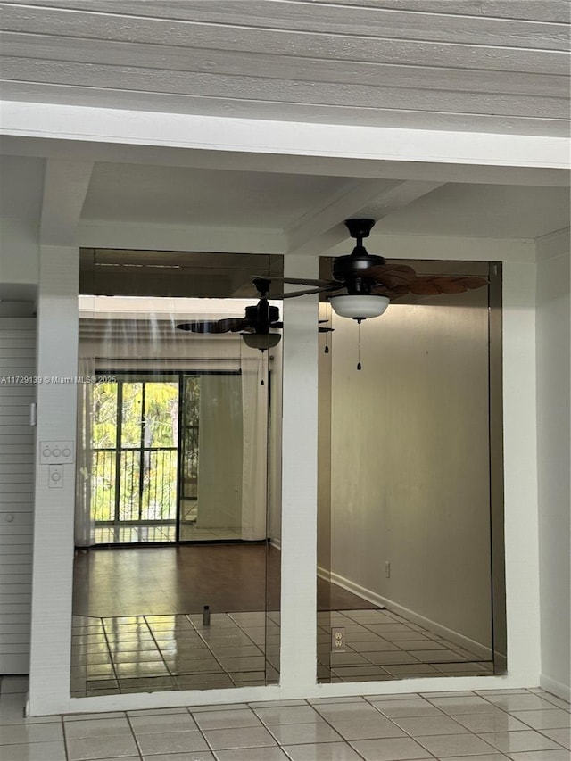 tiled empty room featuring ceiling fan