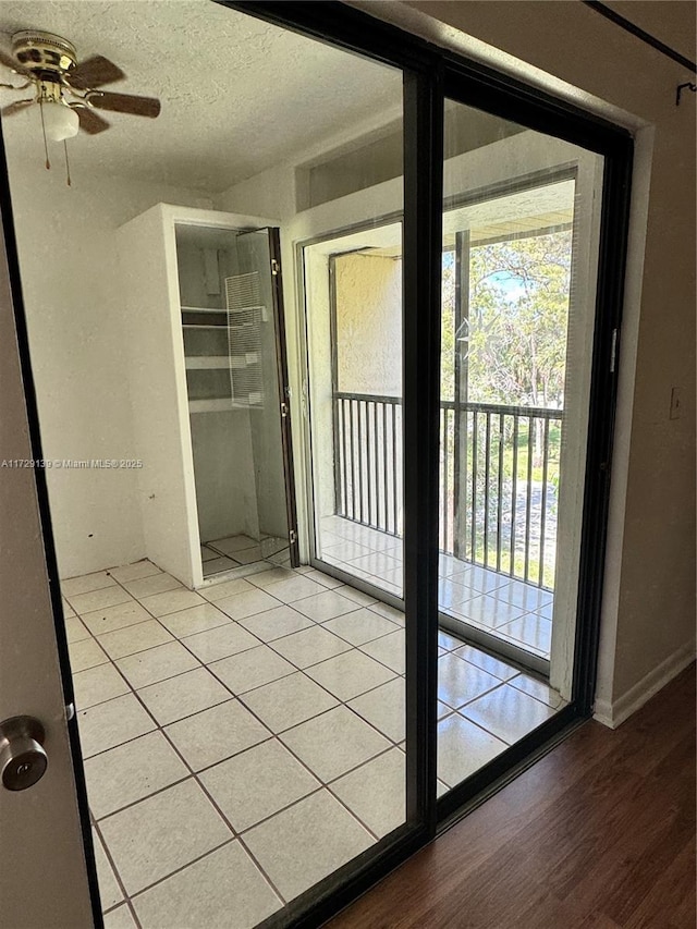 doorway featuring a textured ceiling and light hardwood / wood-style flooring