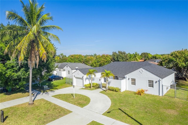 single story home featuring a garage and a front lawn