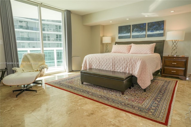 bedroom featuring a wall of windows and access to outside