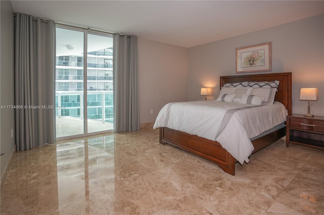 bedroom with floor to ceiling windows and access to outside