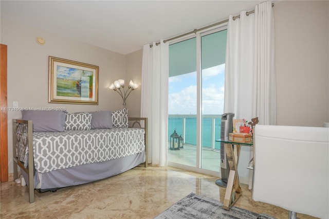 bedroom with a water view, floor to ceiling windows, and access to exterior