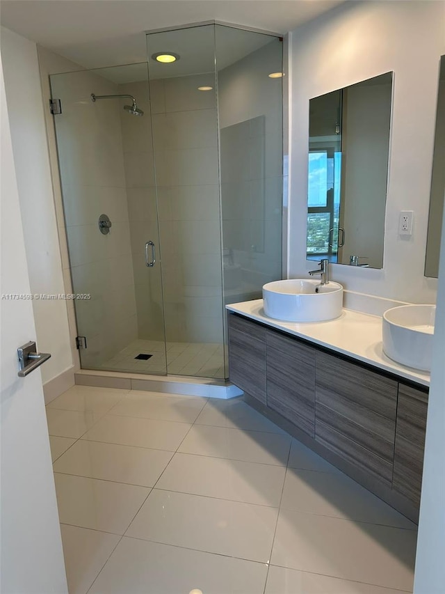 bathroom featuring an enclosed shower, vanity, and tile patterned flooring