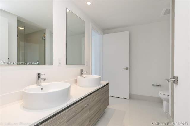 bathroom with vanity, tile patterned floors, and toilet