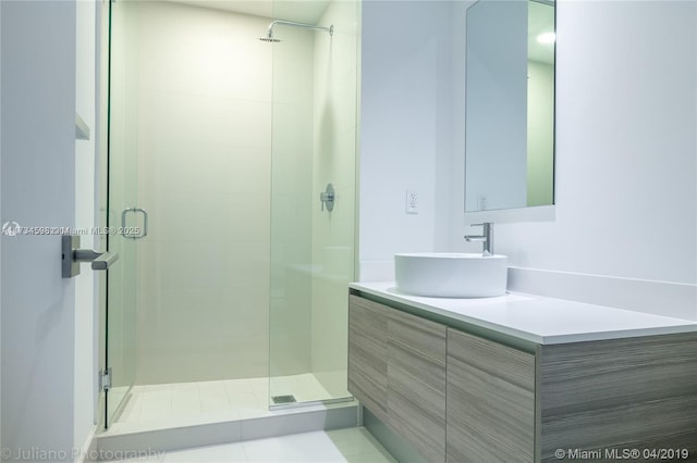 bathroom featuring walk in shower and vanity